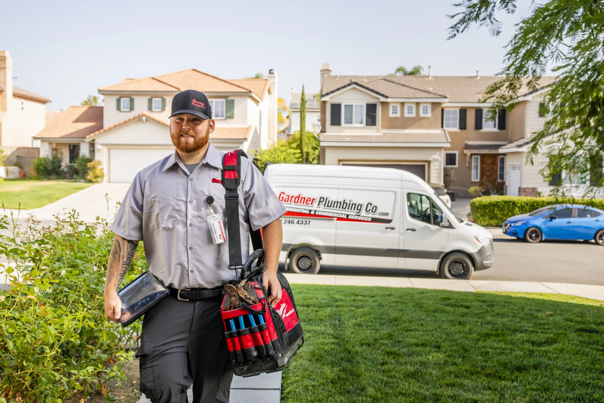 Happy customers shaking hands with Gardner Plumbing technician showing trust and satisfaction