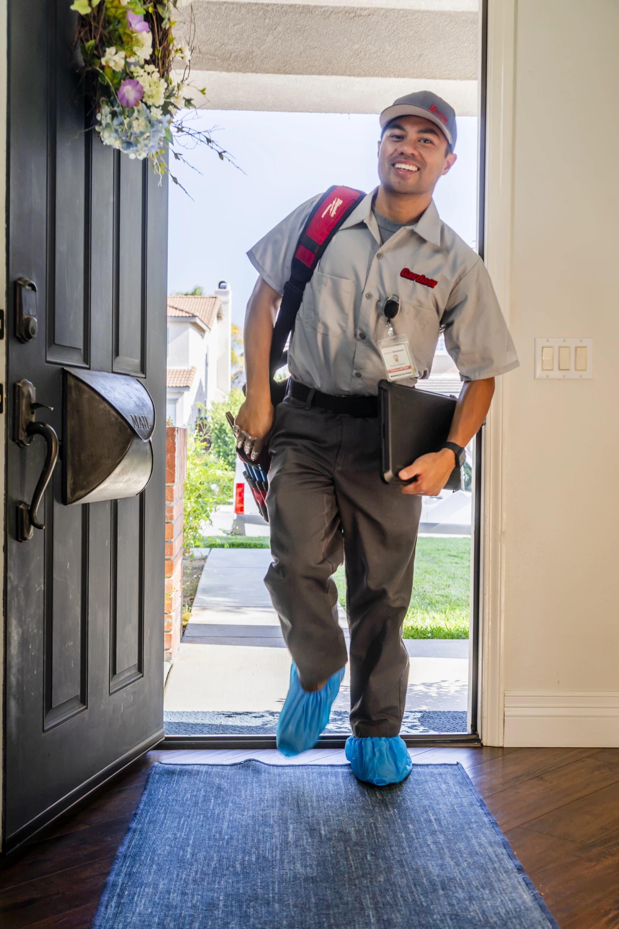 Gardner Plumbing Co. technician repairing toilet