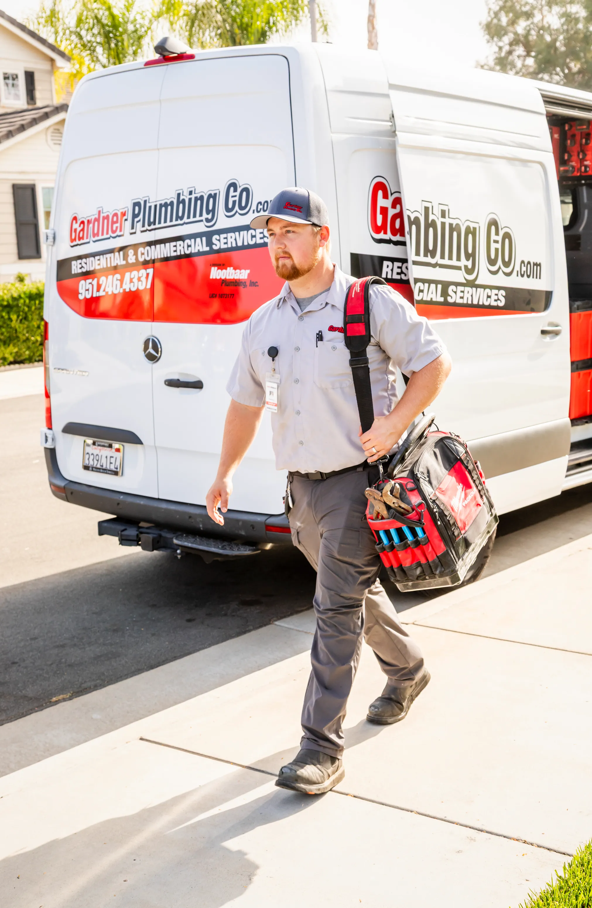 Professional Gardner Plumbing Co. technician with drain cleaning equipment